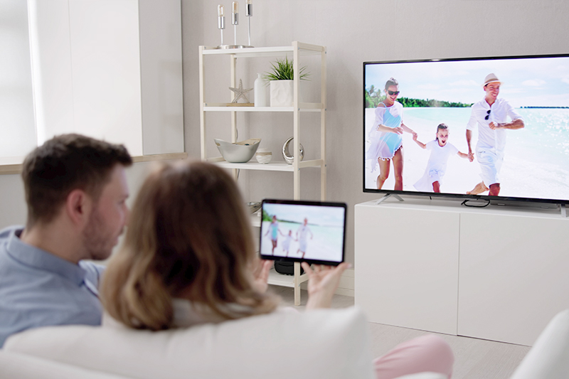 Couple watching TV and tablet